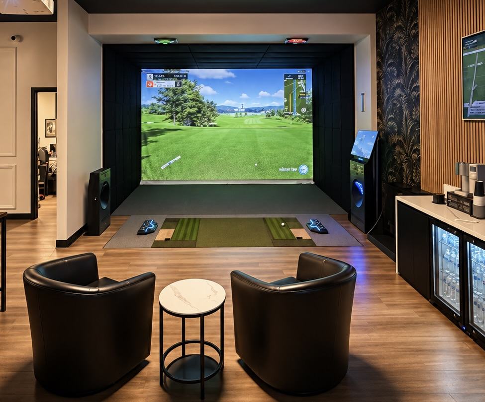 A GOLFZON simulator bay with lounge seating and a refreshment bar