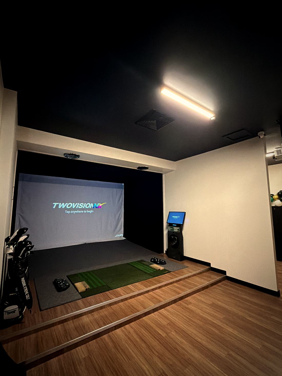 A TwoVisionNX simulator bay with PXG clubs ready to play