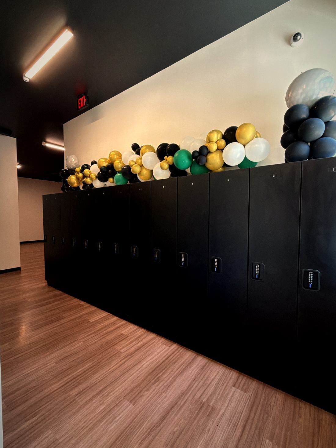 Private black lockers with keypad locks along the club hallway