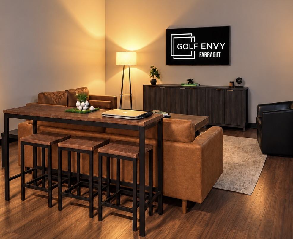 The lounge with leather sofas and a Golf Envy Farragut display